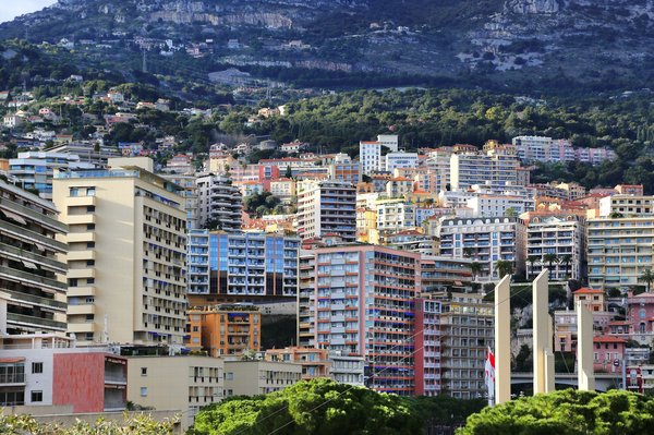 What are the advantages of buying a luxury flat in Monaco?